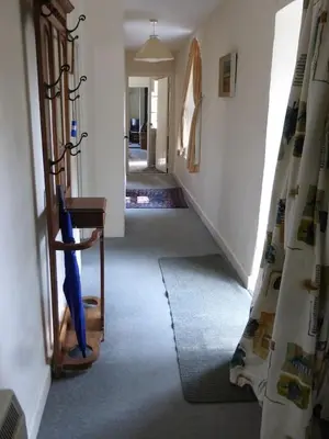 a hallway of a house with a stairway at The Old Stables of heritage Tregrehan Garden Cottages on South Coast in St Austell