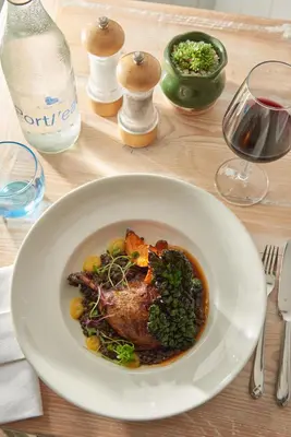 a white bowl of food on a table at Lugger Hotel ‘A Bespoke Hotel’ in Portloe