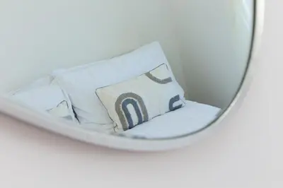 a mirror reflection of a bed with pillows at SeaBreeze 3 - seaview & Parking in St Ives