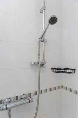 a shower with a shower head in a bathroom at SeaBreeze 3 - seaview & Parking in St Ives