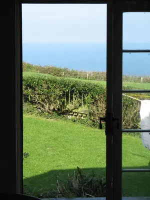 a view from a window of a field of grass at Church Cottage in Bude