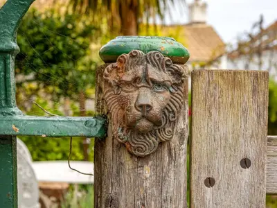 a statue of a lion on a wooden fence at Holiday Home The Homestead by Interhome in Gorran Haven