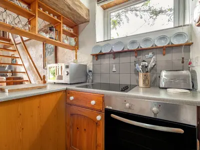 a kitchen with a stove and a counter top at Holiday Home The Homestead by Interhome in Gorran Haven