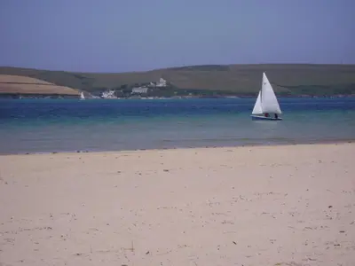 a sail boat in the water on a beach at 10 Trehawks in Wadebridge