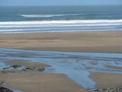 an aerial view of a beach with the ocean at The Old Farmhouse in Crackington Haven