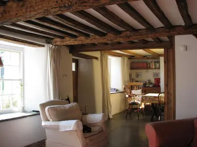a living room with a couch and a table at The Old Farmhouse in Crackington Haven