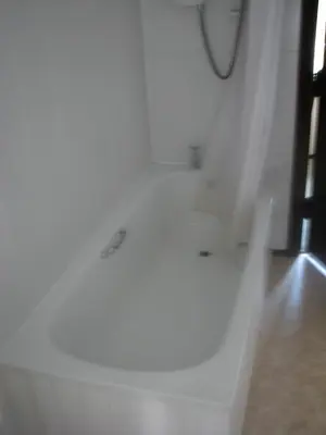 a white bathroom with four sinks and a mirror at The Old Farmhouse in Crackington Haven