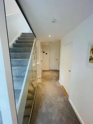 a hallway with blue stairs in a house at 3 Bedroom Holiday Home by beach in Newquay in Newquay