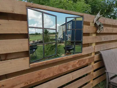 a house with mirrors on the side of it at Dot May in Wadebridge