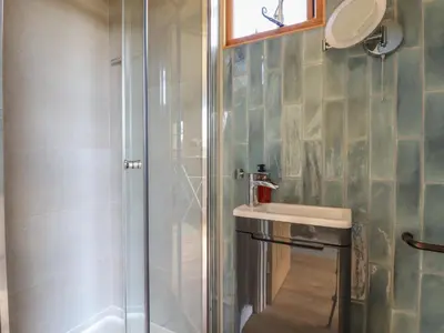 a bathroom with a sink and a shower at Dot May in Wadebridge