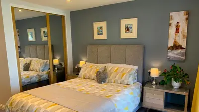 a bedroom with a bed with a cat sitting on it at Portmellon Cove Guest House in Mevagissey