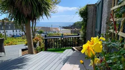 a balcony of a house with a view of the ocean at Portmellon Cove Guest House in Mevagissey