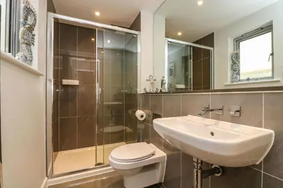 a bathroom with a toilet and a sink and a shower at Apartment 3 Fistral Beach in Newquay