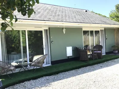 a screened in porch with chairs and a table at Wadebridge Whitecross studio 1 in Wadebridge