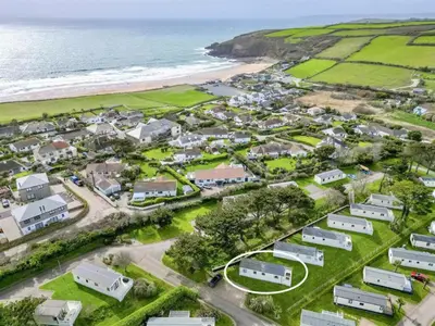 an aerial view of a village next to the ocean at Pottsville Cabin Sleeps 4 with Deck in Praa Sands