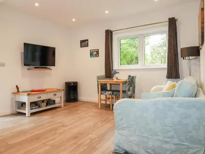 a living room with a couch and a table at Pheasant View in Truro