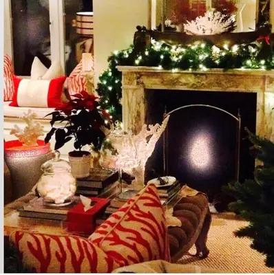 a living room with a fireplace with christmas decorations at BBCFeatured LuxuryInteriorDesignedWaterfront Home. in Saint Mawes