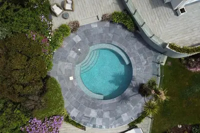 an overhead view of a swimming pool in a yard at BBCFeatured LuxuryInteriorDesignedWaterfront Home. in Saint Mawes