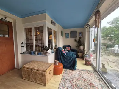 a living room with a blue ceiling at Tregarth House in St Austell