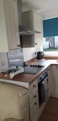a kitchen with white cabinets and a stove top oven at 11 Trevithick Court Tolroy Manor in Hayle