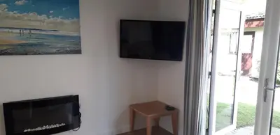 a flat screen tv hanging on a wall next to a window at 11 Trevithick Court Tolroy Manor in Hayle