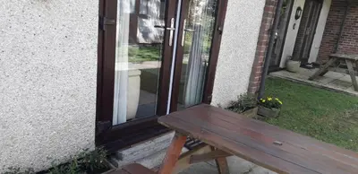 a wooden bench sitting in front of a door at 11 Trevithick Court Tolroy Manor in Hayle