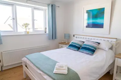 a bedroom with a bed with two towels on it at Trethvor House FREE PARKING, Ensuite Double Quiet residential area in Padstow