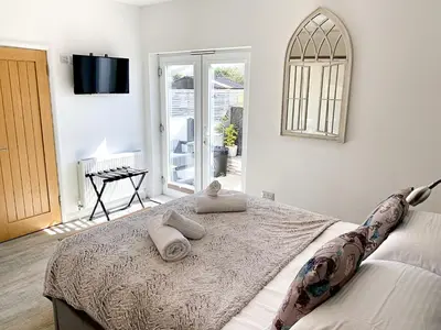 a bedroom with a bed with two pillows on it at Meadow View Apartments in Newquay