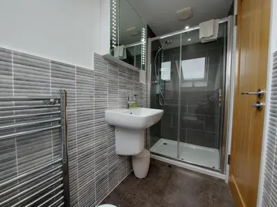 a bathroom with a sink and a shower at Meadow View Apartments in Newquay