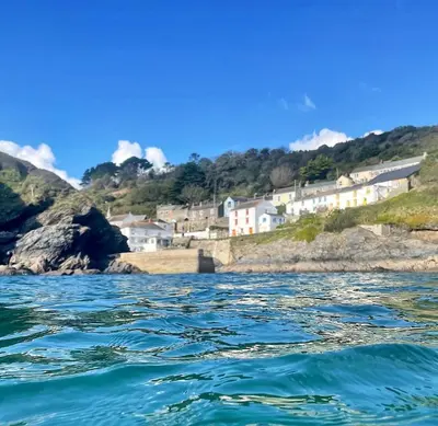 a view of a body of water with houses at Just Opened. Romantic Clifftop Retreat in Portloe