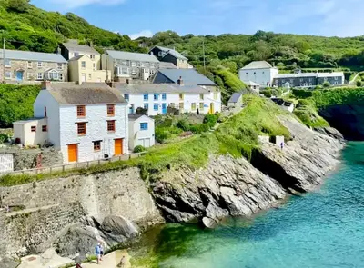 a village on the shore of a body of water at Just Opened. Romantic Clifftop Retreat in Portloe