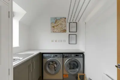 a laundry room with two washer and dryer at The Hawthorns in Polzeath