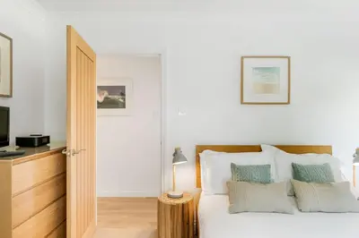 a bedroom with a bed and a television at The Hawthorns in Polzeath