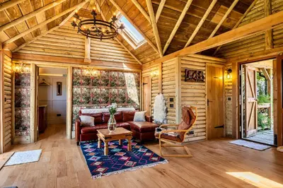 a living room with a couch and a table at Finest Retreats - Driftwood in Poundstock