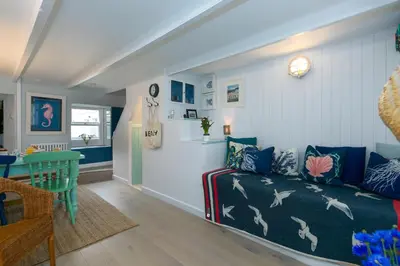 a living room with a couch and a table at Puffin Cottage in St Ives