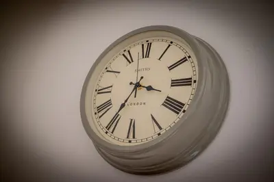 a clock with roman numerals on a wall at The Decker Apartment in Looe