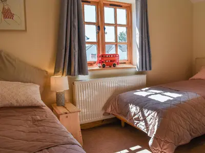 a bedroom with two beds and a window at The Potting Shed in Par