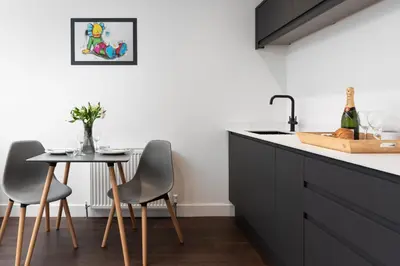 a kitchen with a table and two chairs and a sink at Room 2 Hotel style Double bedroom in Marazion in Marazion