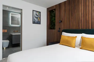 a bedroom with a white bed with yellow pillows at Room 2 Hotel style Double bedroom in Marazion in Marazion