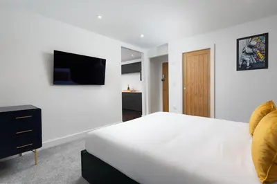 a white bedroom with a bed and a tv at Room 2 Hotel style Double bedroom in Marazion in Marazion