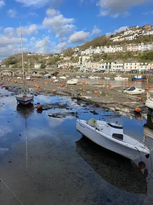a group of boats sitting in the water in a harbor at The Hillocks, Looe - Two Bedroom House with Fabulous Views of Looe Town and Harbour in Looe