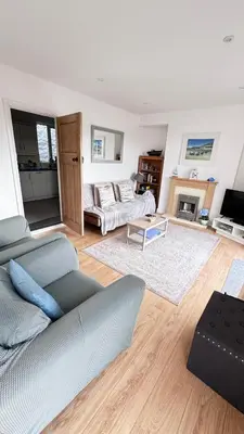 a living room with a couch and a fireplace at The Hillocks, Looe - Two Bedroom House with Fabulous Views of Looe Town and Harbour in Looe