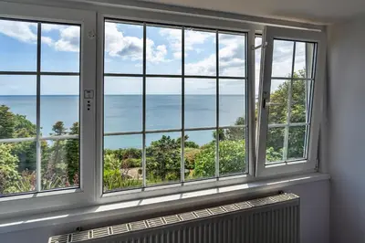 a room with a window with a view of the ocean at Finest Retreats - Tregatreath in Coverack
