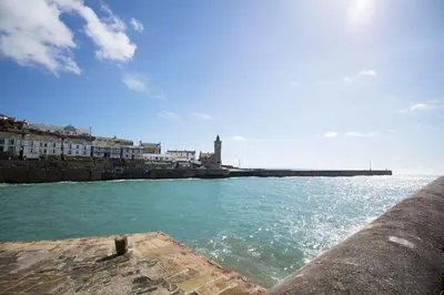 a view of a body of water with a pier at Porthleven Glamping in Porthleven