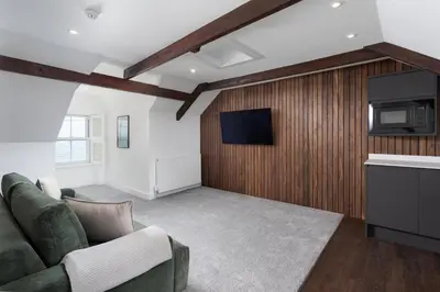 a living room with a couch and a tv at Luxury Modern Suite in Marazion with Parking in Marazion