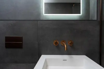 a bathroom with a white sink and a mirror at Luxury Modern Suite in Marazion with Parking in Marazion