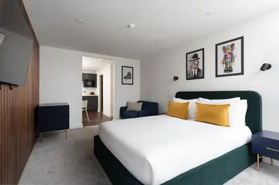a bedroom with a large white bed with yellow pillows at Room 3 Hotel style Double bedroom in Marazion in Marazion