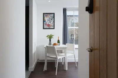 a white dining room with a white table and chairs at Room 3 Hotel style Double bedroom in Marazion in Marazion