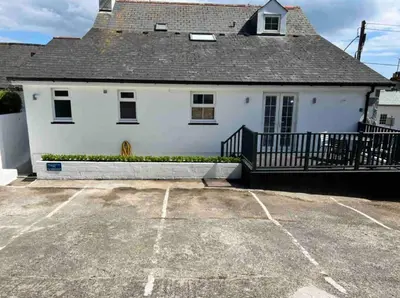 a white house with a porch and a driveway at Room 1, Hotel style double bedroom in Marazion in Marazion