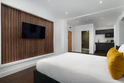 a bedroom with a large bed with a television on a wall at Room 1, Hotel style double bedroom in Marazion in Marazion